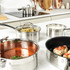 Set of three stainless steel saucepans with handles, nested side by side