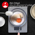 Kitchen scale weighing baking ingredients in a glass bowl, showing add and weigh feature.