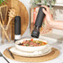 Set of black Salter salt and pepper grinders on kitchen shelf