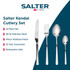 Hand holding fork with slice of sponge cake on cream stoneware plate, with coffee and cutlery