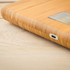 Close-up of bamboo digital scale corner showing USB-C charging port
