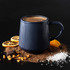 Navy ribbed mug of hot chocolate with chocolate, toffee, orange slices and sea salt.