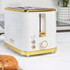 White and gold toaster with removable crumb tray extended on a kitchen counter