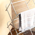 Foldable clothes airer with light grey striped towel draped over rail