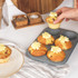 Grey non-stick six-cup muffin tray with speckled finish, top view