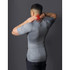Black mesh massage cushion with power button detail, close-up