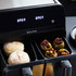 Salter dual air fryer with two drawers, one cooking bread rolls, one stuffed vegetables.