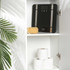 Black digital bathroom scale with silver accents on shelf beside bath sponge