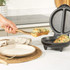 Black non-stick breakfast maker, open, showing two deep compartments
