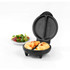 Black omelette maker with two filled omelettes, served beside a plate of salad