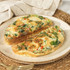Vegetable omelette halves on plate, showing cooked eggs with spinach and peppers