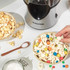 Hot air popcorn maker with kernels and popped corn in clear chamber