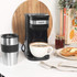 Black Salter single-serve coffee maker with travel mug on kitchen counter