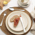 Set of four silver cutlery pieces on cream stoneware plates, for product listing