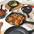 Set of non-stick stone-effect frying pans with cooked chicken, omelette, and tomato dishes