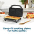 Black electric waffle maker open on kitchen worktop