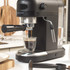 Black Salter espresso coffee machine with steam wand, shown with scoop and filter.