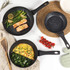 Set of black speckled non-stick frying pans and saucepans on a kitchen counter