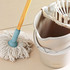 White mop with wooden handle and matching white plastic bucket with wringer