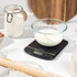 Black Salter digital kitchen scale with glass bowl of brown sugar on display