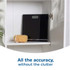 Black digital bathroom scale stored on a white shelf