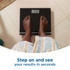 Person standing on black digital bathroom scales showing 71.2kg