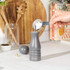 Grey Salter salt or pepper mill being filled with salt using a measuring spoon