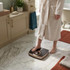 Bathroom cabinet open showing gold and black analogue bathroom scales and towels