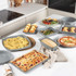 Set of grey speckled non-stick bakeware, various shapes and sizes, on kitchen worktop
