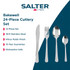 Table setting with cream stoneware plates, stainless steel cutlery and linen napkin on woven placemat