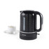 Black electric kettle with ribbed design beside cup of tea, side view