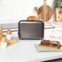 Gunmetal toaster, microwave, and kettle set on kitchen counter