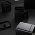 Set of black metal kitchen storage tins with lids, shown on dark surface