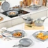 Grey non-stick frying pan with glass lid on kitchen counter