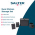 Set of black metal kitchen storage tins, including one open with tea bags, on countertop