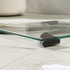 Glass digital bathroom scale with black accents and large display, showing 0.0 kg