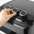 Hand adjusting control dial on black air fryer