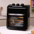 Black Salter air fryer oven with three control dials, shown on kitchen counter