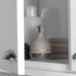 Salter grey electric dish brush with handle, shown in a kitchen cupboard with sponges.