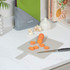 Chopping board with sliced carrot and knife on kitchen counter