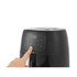 Hand pressing power button on black digital air fryer with illuminated touchscreen