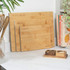 Bamboo chopping board with citrus fruits and knife on kitchen counter