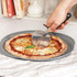 Grey pizza crisping tray with perforated base, shown from above