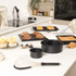 Product listing image: non-stick black baking tins set shown in kitchen with pastries and cakes
