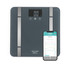Black smart bathroom scale with digital display and smartphone showing health app
