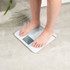 White Salter digital bathroom scale with large display, 32cm x 32cm.