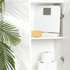 White digital bathroom scale with sponge on shelf, next to toilet rolls in white cupboard