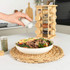 Wooden spice rack with assorted jars on kitchen counter, bowl of salad in foreground