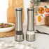 Set of stainless steel salt and pepper mills on kitchen shelf