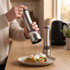Pair of stainless steel electric salt and pepper grinders on kitchen worktop